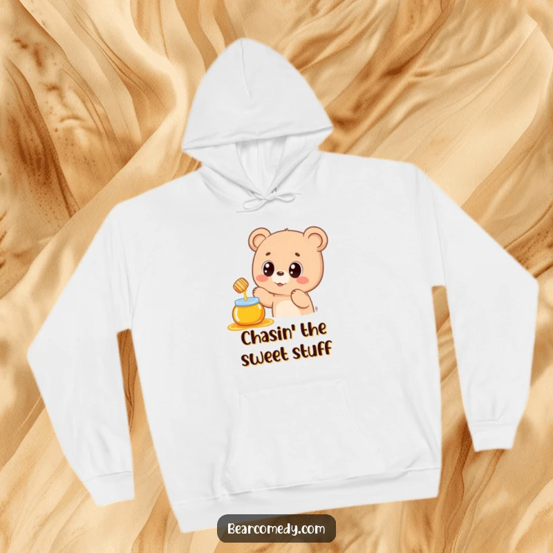 Funny hoodie with a kawaii bear adorably reaching for a delicious honey pot, radiating warmth, cuteness, and a touch of sweet mischief.