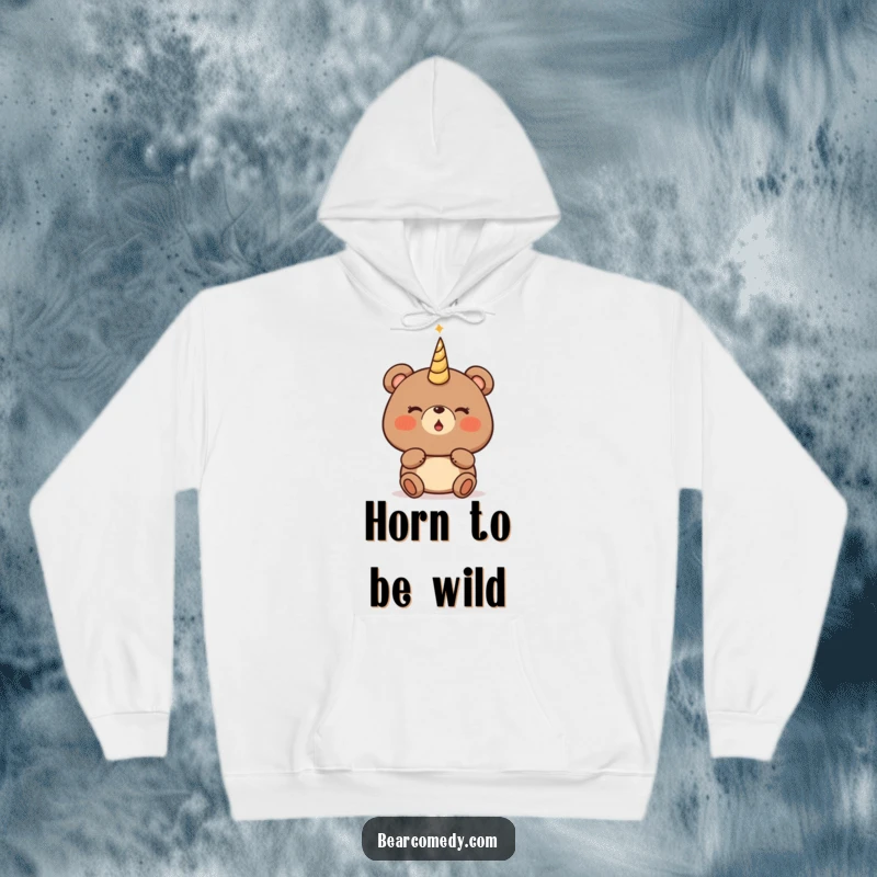 Funny bear hoodie with a character sporting rosy cheeks, about to blow a magical, glowing horn, radiating wonder.