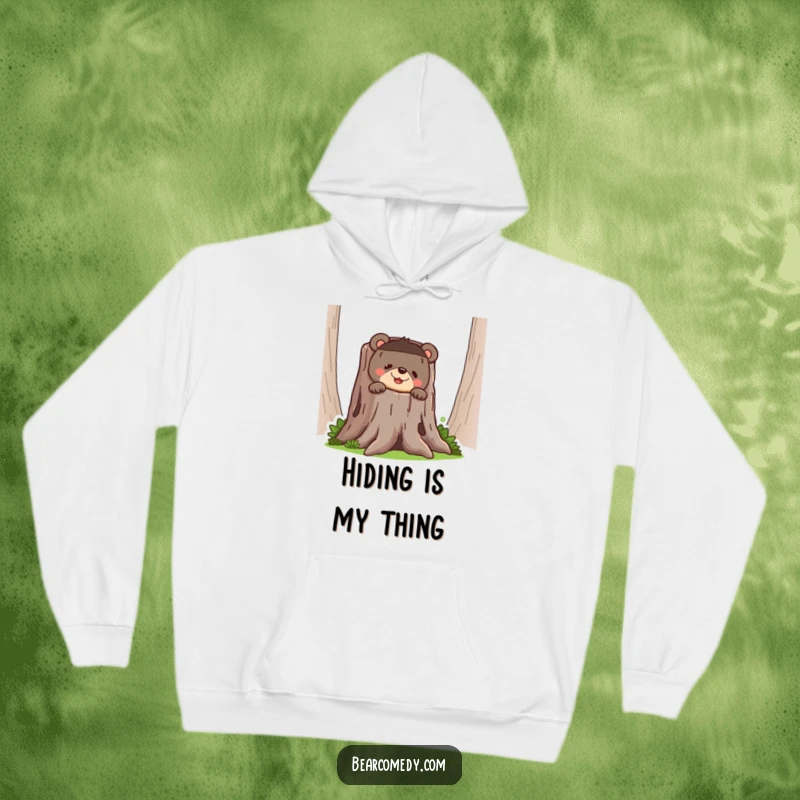 Funny bear hoodie showing a bear peeking mischievously from behind a large tree stump with a wide, humorous grin.