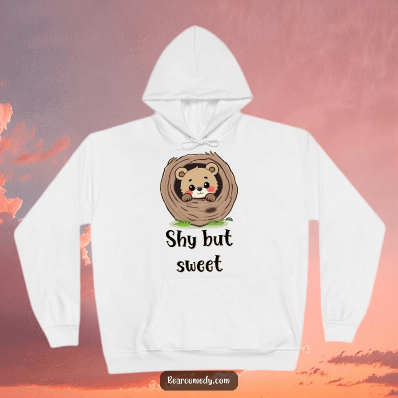 Funny curious bear peeking from behind a large, fallen log with a gentle gaze, a warm and inviting hoodie.