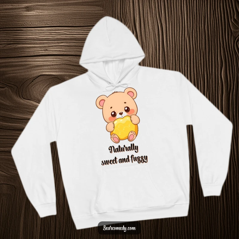 Funny adorable bear character with big round eyes, happily hugging a giant honeycomb, a cozy hoodie for sweet dreams.