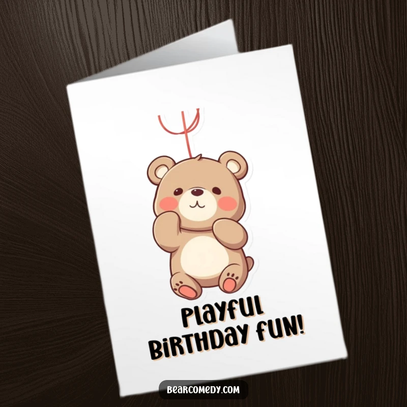 Funny Free Printable Birthday Card: A bear playfully batting at a dangling, bright red string with focused intensity.