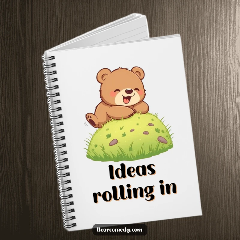 Funny notebook cover showing a bear cub rolling down a grassy hill, symbolizing carefree movement and happy thoughts, ideal for journaling or notes.