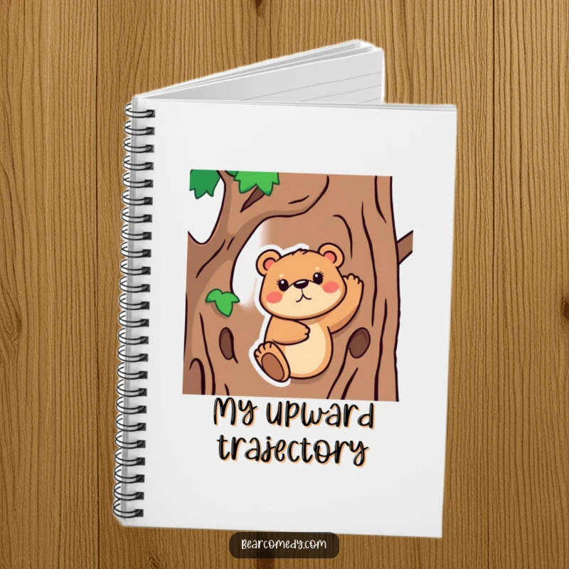 Funny Notebook featuring a bear animal with a determined face, trying to climb a tree, perfect for jotting down goals with humorous determination.